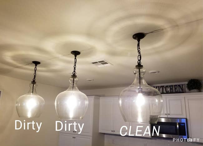 reviewer's three glass pendant lights, two foggy and dirty and one clean and clear