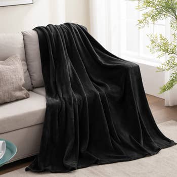 the black blanket laid out on a couch