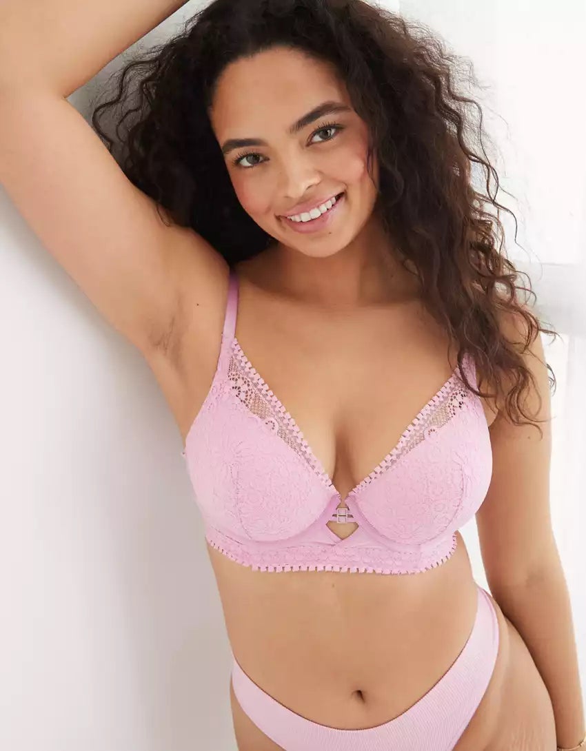 a model posing in a pink lace plunge bra and pink panties