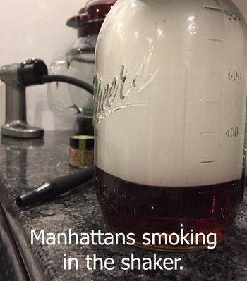 reviewer image of jar filled with smoke and product behind it with writing that says manhattans smoking in the shaker