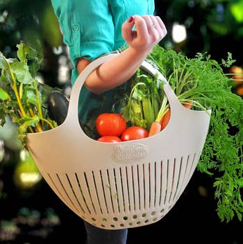 A model holding veggies in the colander