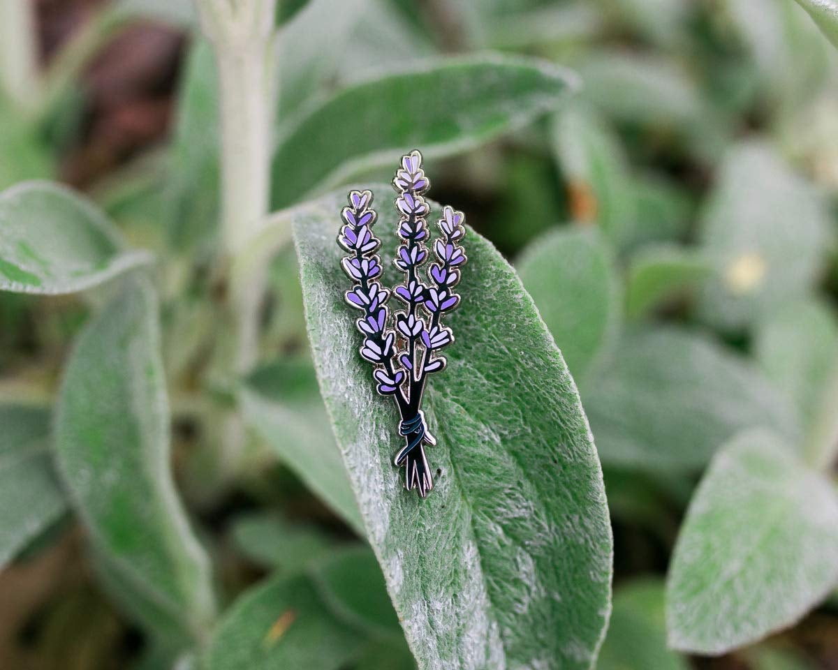 an enamel pin of a sprig of lavender