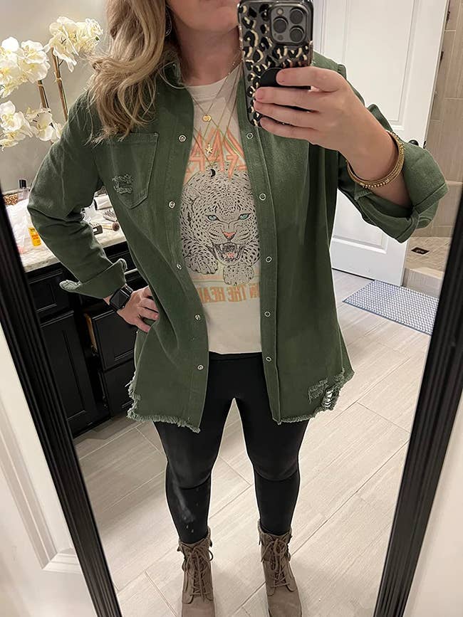reviewer wearing the dark green jacket over a t-shirt and leggings