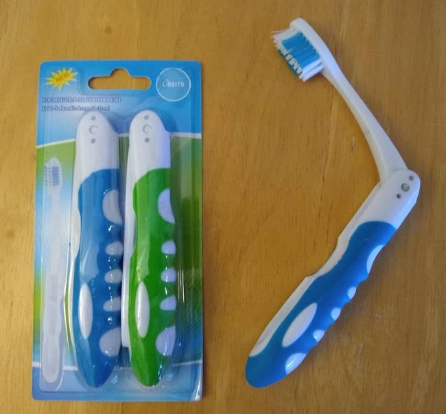 two blue and green toothbrushes folded compactly in the packaging and another one opened to reveal the brush head