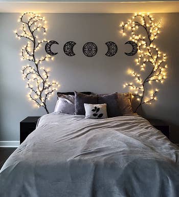 reviewer's bed with two glowing tree vines on either side of the wall 