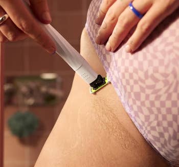 Person shaving their interior thigh