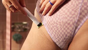 Person shaving their interior thigh