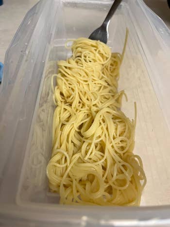 A fork successful  a instrumentality  of cooked spaghetti, perchance  highlighting kitchenware for repast  prep