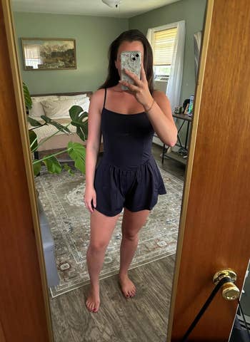 Person taking a reflector  selfie wearing a stylish, sleeveless romper successful  a casual location  setting