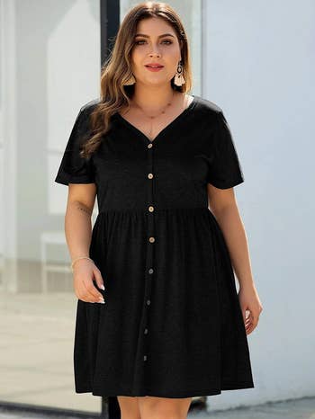 model wearing black dress with buttons 