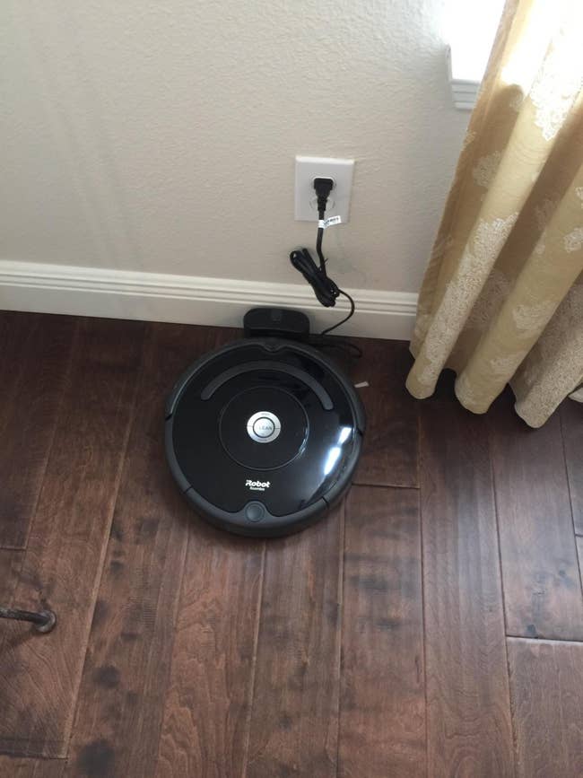 reviewer image of the roomba plugged in and charging