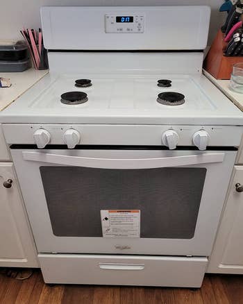 A reviewer's after photo which shows the same white stove looking brand new