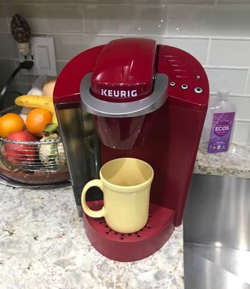 Reviewer photo of the Keurig coffee maker with a mug placed under the dispenser in a home kitchen setting
