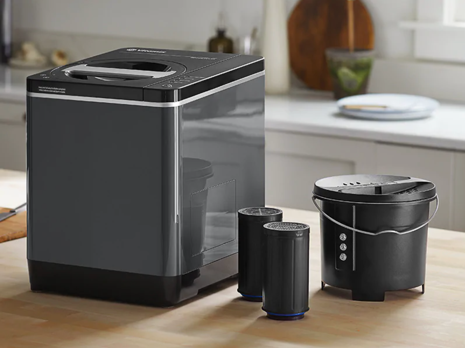 the FoodCycler and two carbon filters on a wooden kitchen counterop