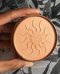 reviewer holding the bronzer