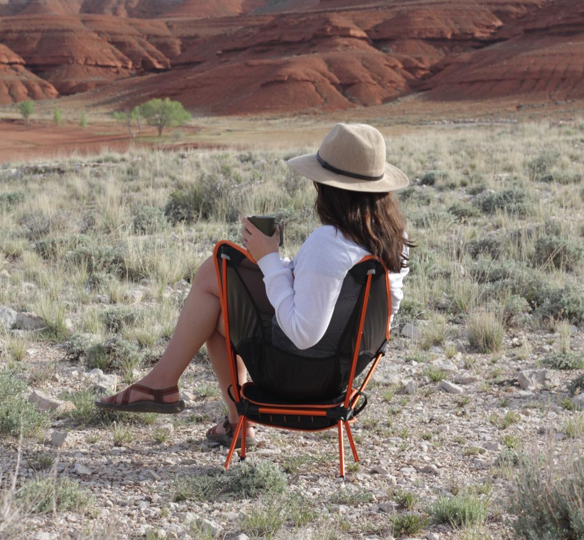 Reviewer photo sitting in chair next to a canyon