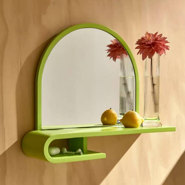 A lime green shelf with a mirror attached