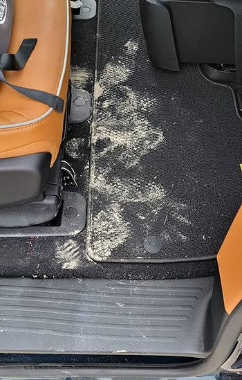 reviewer before image of a dirty car rug