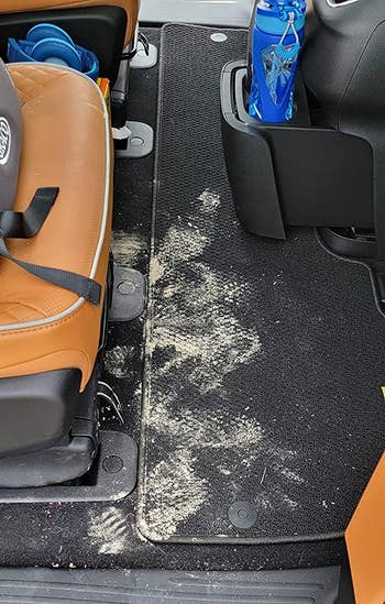 reviewer before image of a dirty car rug