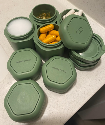 reviewer's green travel-sized toiletry containers on a counter