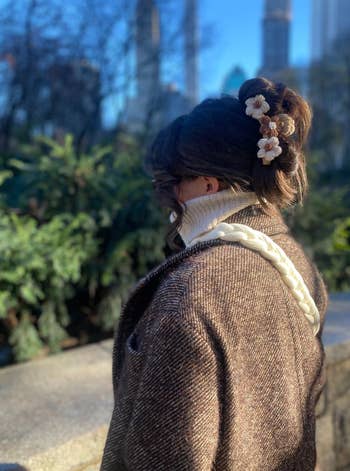 the brown and white floral hair clip in a model's hair