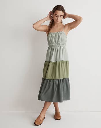 model wearing tiered colorblock midi dress in three shades of gree