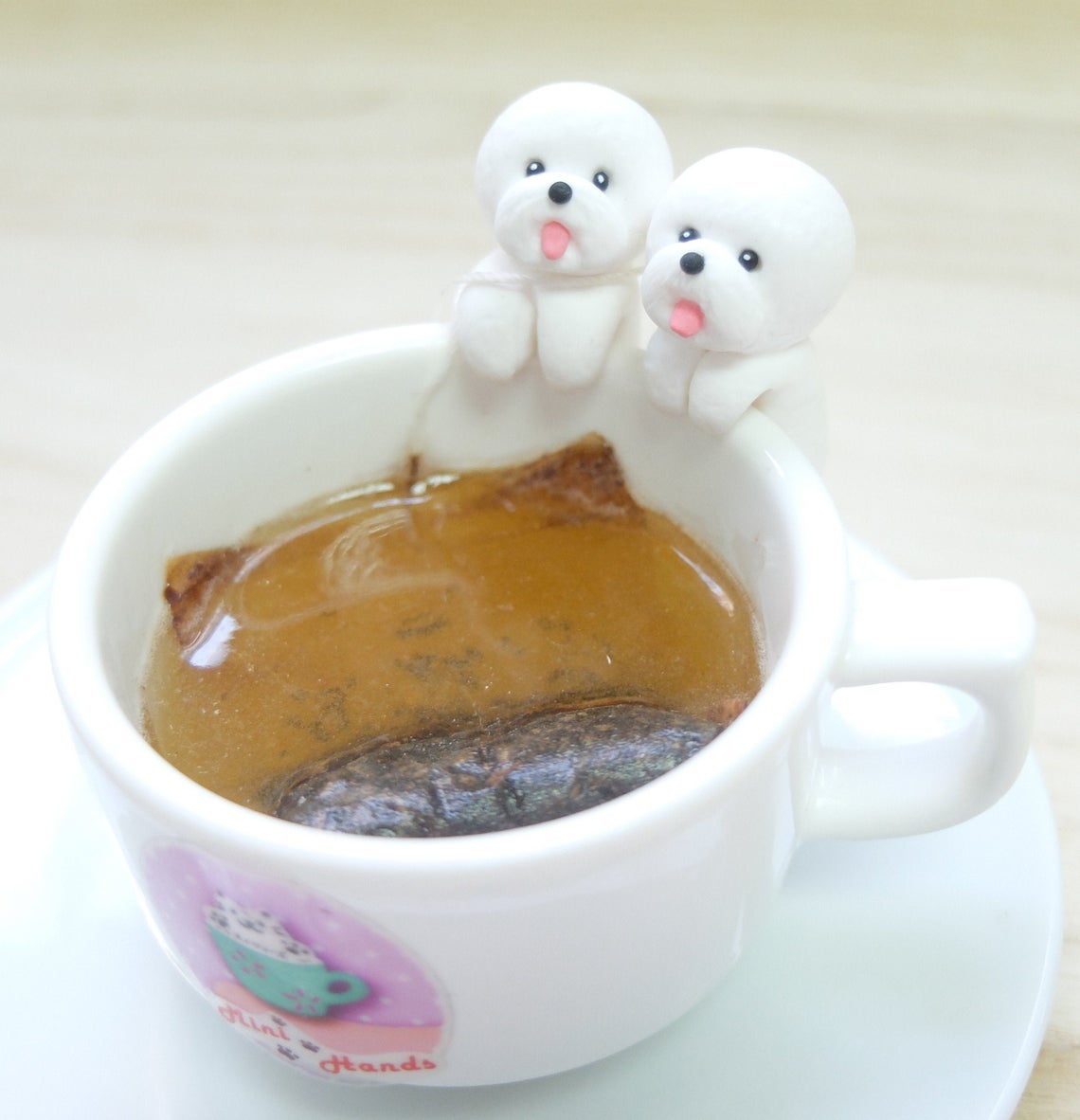 tiny bichons on edge of mug 