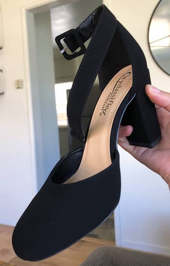 close up of reviewer holding the black heel
