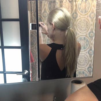 Reviewer with agelong  ponytail earlier  wearing the pins