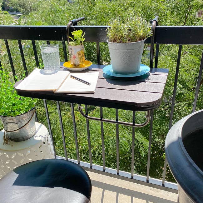 Balcony array  setup with a notebook, pencil, sparkling water, and plants, perfect  for outdoor enactment    oregon  relaxing