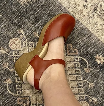 Reviewer wearing red closed-toe sandals
