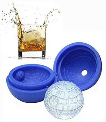 the blue silicone mold shaped like the death star with an ice cube and a drink