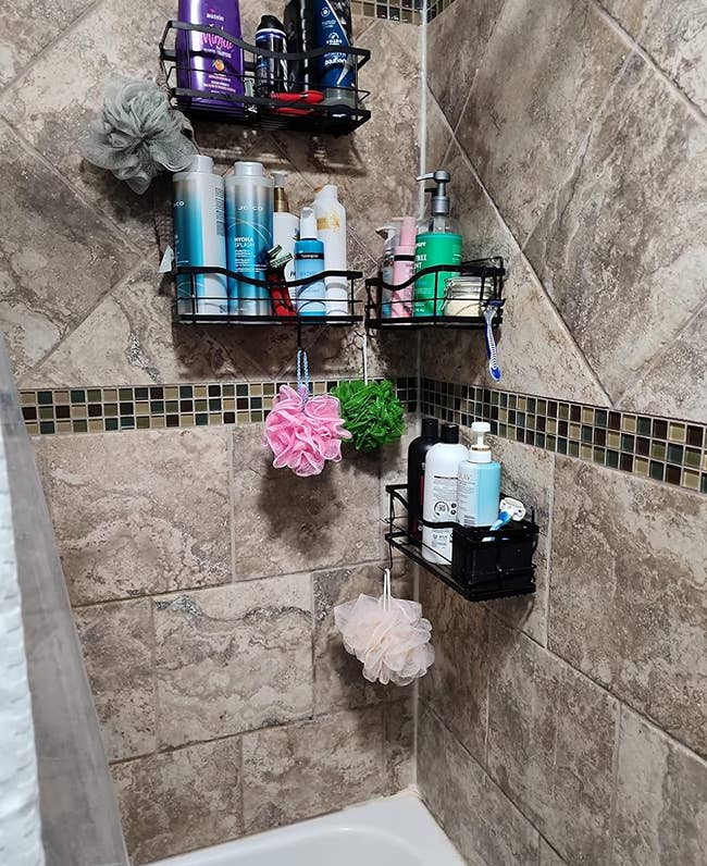 A shower corner with various personal care products organized on wall-mounted shelves