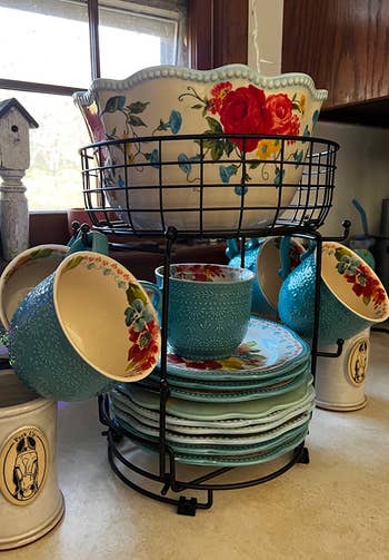 reviewer photo of mug holder with bowl and plates in storage basket