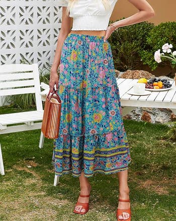 model in tiered blue floral skirt