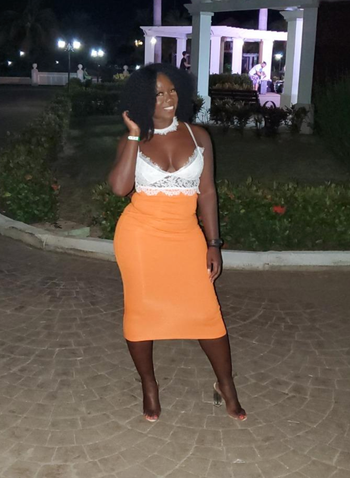 reviewer wearing the orange set with white top 