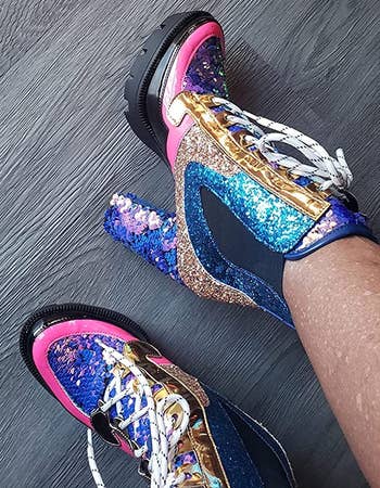 reviewer's feet wearing the multicolored sequined boots