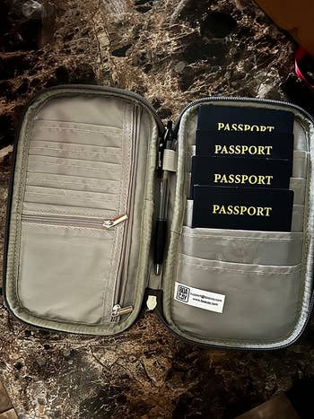 a reviewer photo of the interior of the document holder with several passports inside 