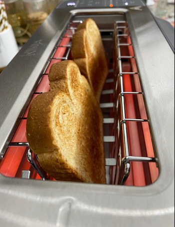 A stainless steel toaster making toast 