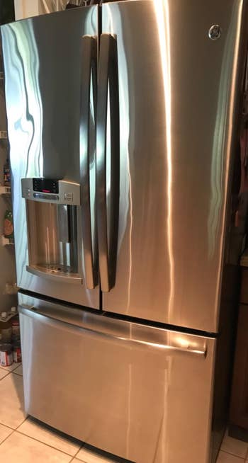 The same stainless steel refrigerator after being cleaned