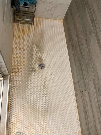 reviewer photo showing their shower tile completely covered in grime and mildew