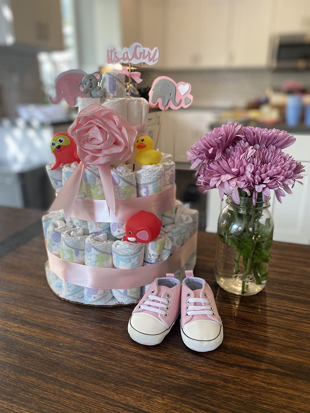 reviewer's photo of the pink shoes at a baby shower