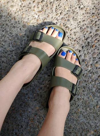 reviewer wearing the birkenstock sandals in green