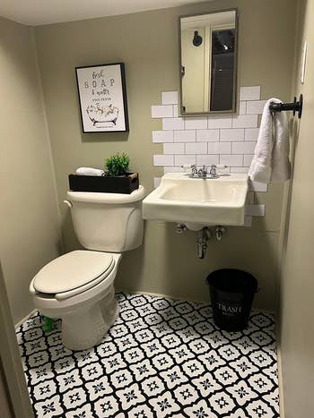 the after photo of a bathroom with new tile that looks much better