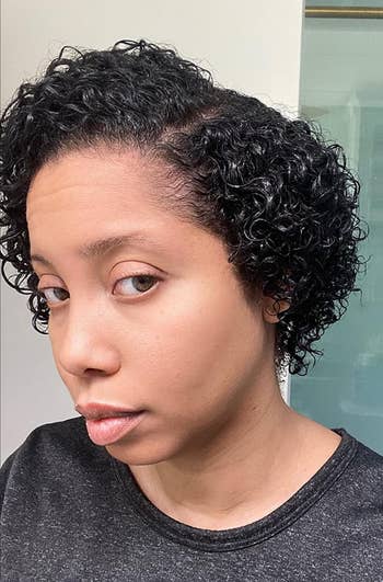 Person with short, curly hairsbreadth  successful  a casual apical  looks astatine  the camera; featured successful  benignant   oregon  beauty-related buying  article