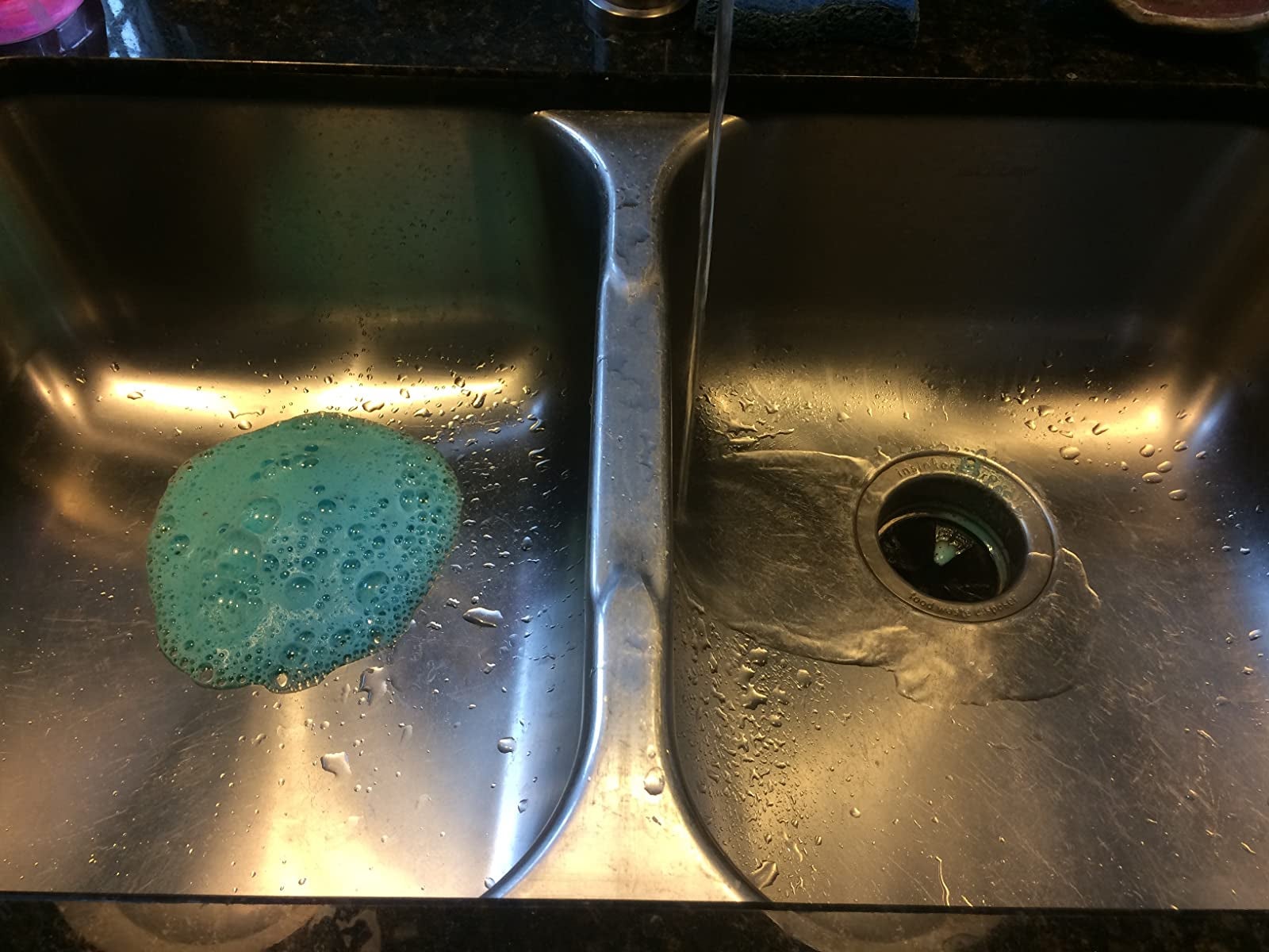 reviewer image of the glisten dishwashing tablet foaming up in the sink