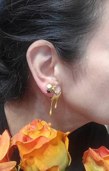 reviewer wearing both earrings in different piercings in one ear