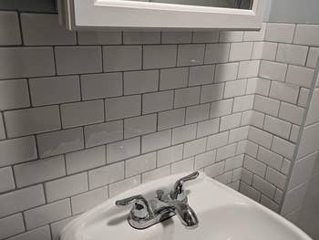 reviewer photo of the white subway tiles above their sink