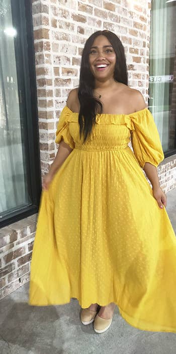 a reviewer in yellow with the sleeves off shoulder