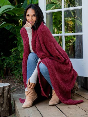 a model wrapped in the cranberry blanket